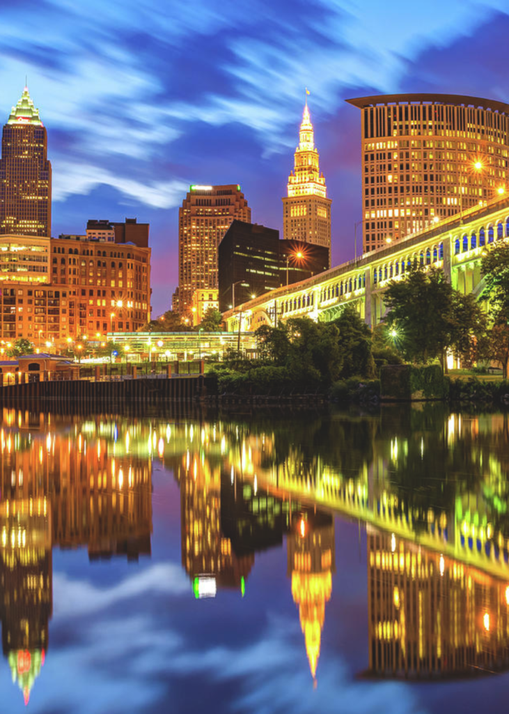 Breathtaking view of Downtown Cleveland, Ohio, with a scenic bridge stretching over the water and the iconic city skyline in the background.